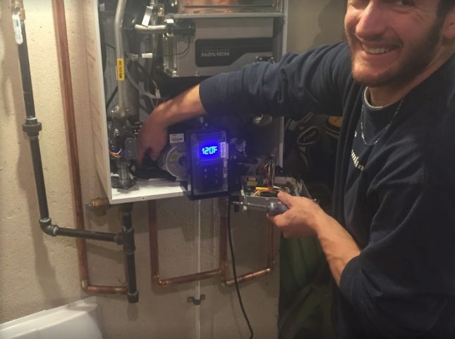 plumber from premier plumbing servicing a water heater